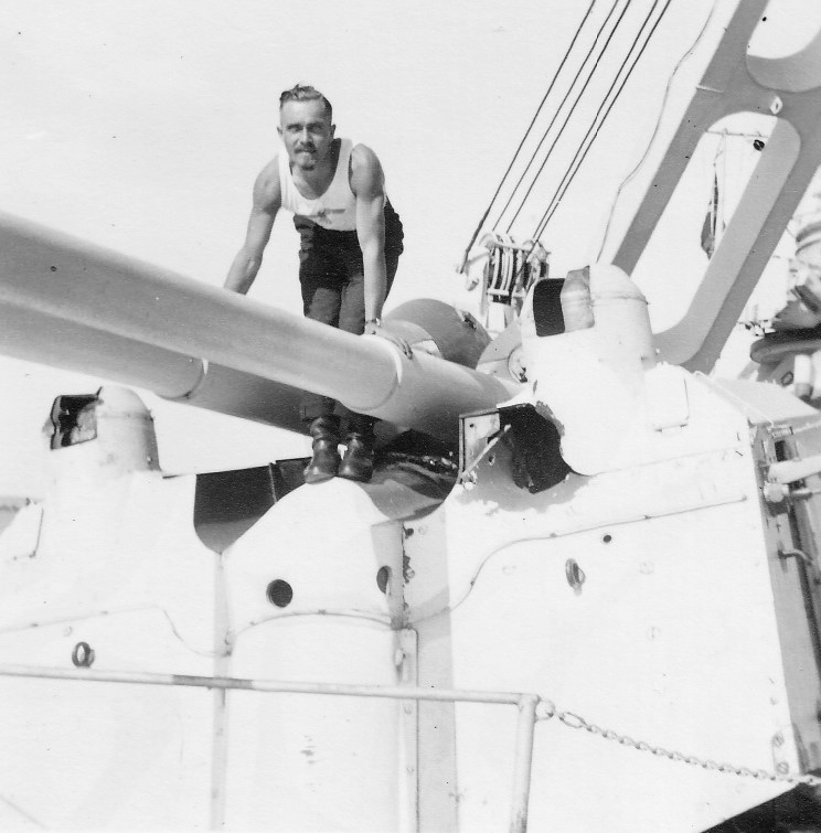 Un marinero se fotografía sobre un montaje de 37 mm alcanzado durante la batalla, el 14 de Diciembre de 1939