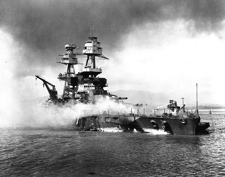Vista del USS Nevada BB-36 varada y ardiendo después de ser alcanzado por las bombas y torpedos japoneses tras el ataque japonés a Pearl Harbor